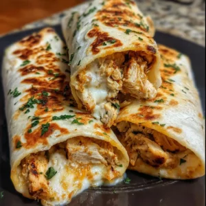 Low Carb Cheesy Garlic Chicken Wraps 3 Low Carb Cheesy Garlic Chicken Wraps on a plate garnished with herbs.