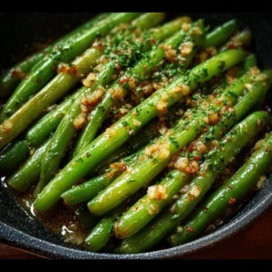 Savory garlic butter green beans served on a plate