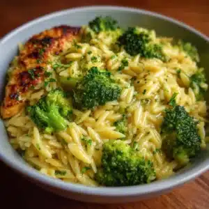 Cheesy Broccoli Orzo 3 Bowl of cheesy broccoli orzo with creamy sauce and fresh broccoli florets