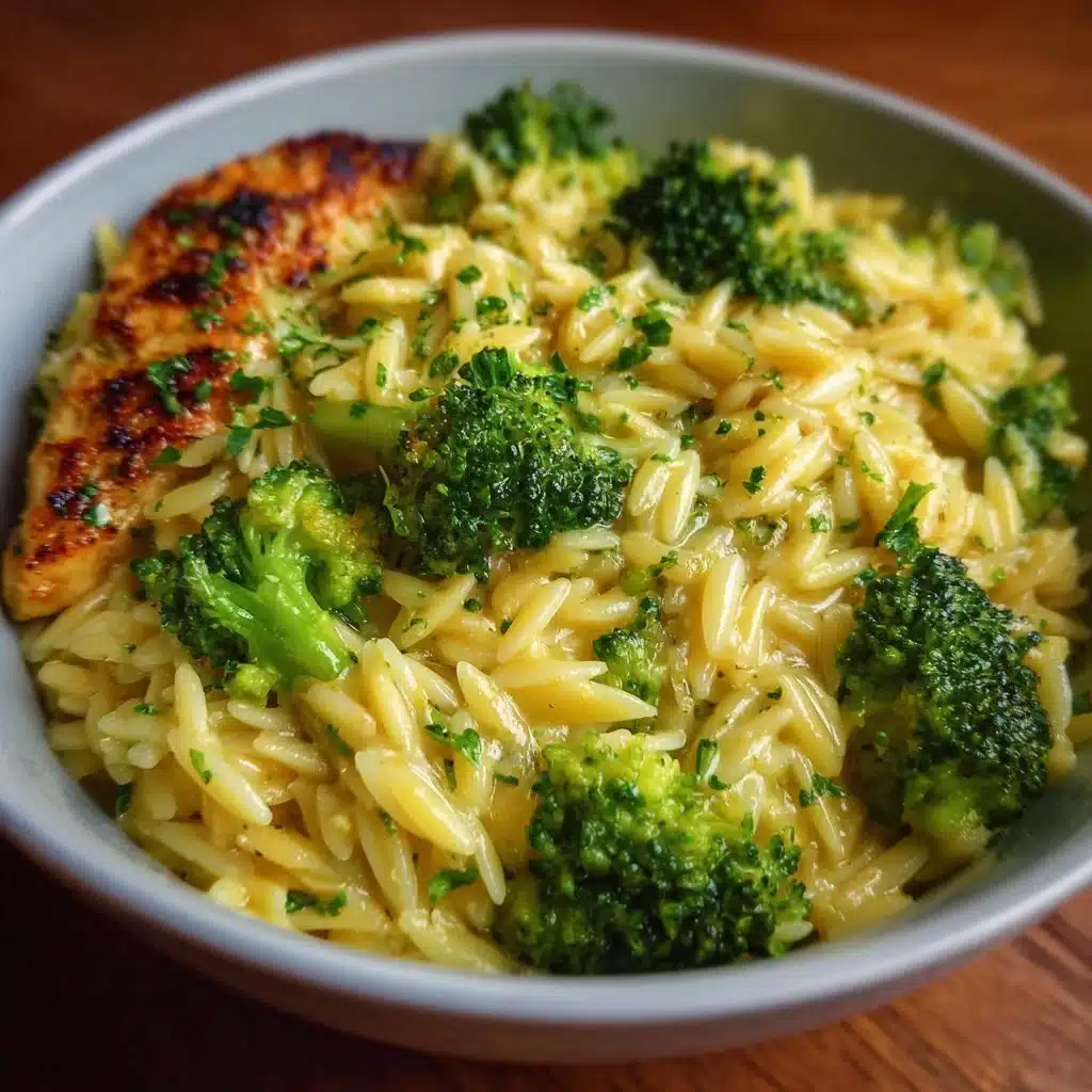 Bowl of cheesy broccoli orzo with creamy sauce and fresh broccoli florets