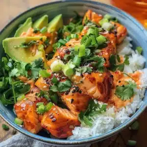 Bang Bang Salmon Bowls topped with coconut rice and vegetables.