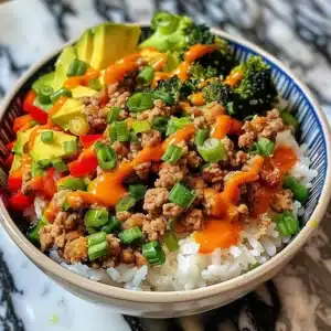 Bang Bang Ground Turkey Rice Bowls topped with fresh vegetables and sauce