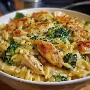 Cheesy chicken with broccoli and orzo served on a plate