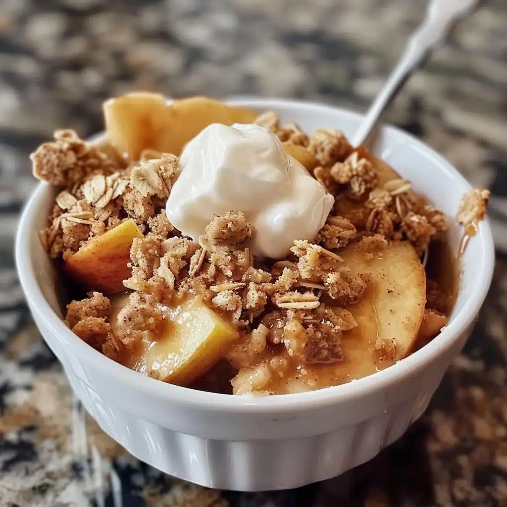 Healthy high protein apple crisp served in a bowl with a spoon.