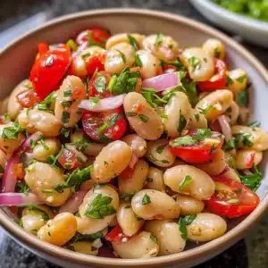 Vibrant salad with white beans, fresh vegetables, and dressing